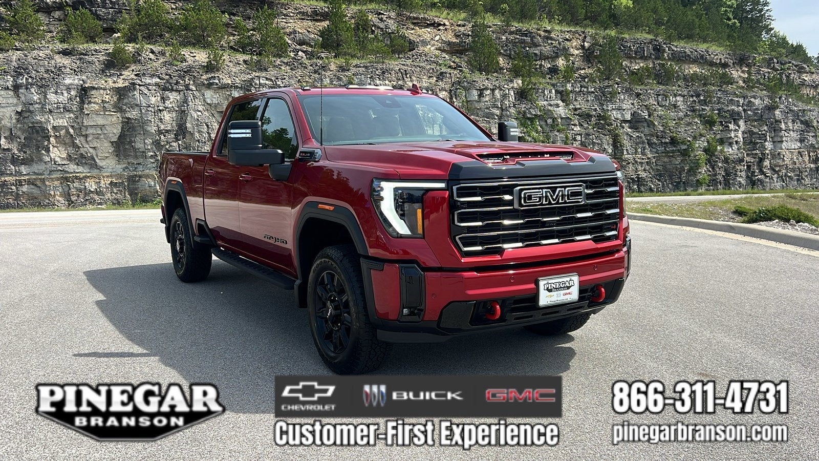 2026 GMC Sierra 2500 HD AT4 in Volcanic Red Tintcoat — front three-quarter view