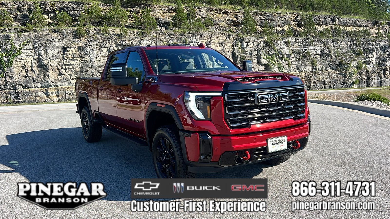2026 GMC Sierra 2500 HD AT4 in Volcanic Red Tintcoat — front three-quarter view